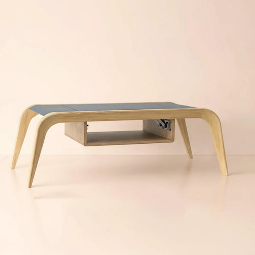 A luxury extendable oak coffee table with a dark blue top and a light pink background, professionally lit for e-commerce.
