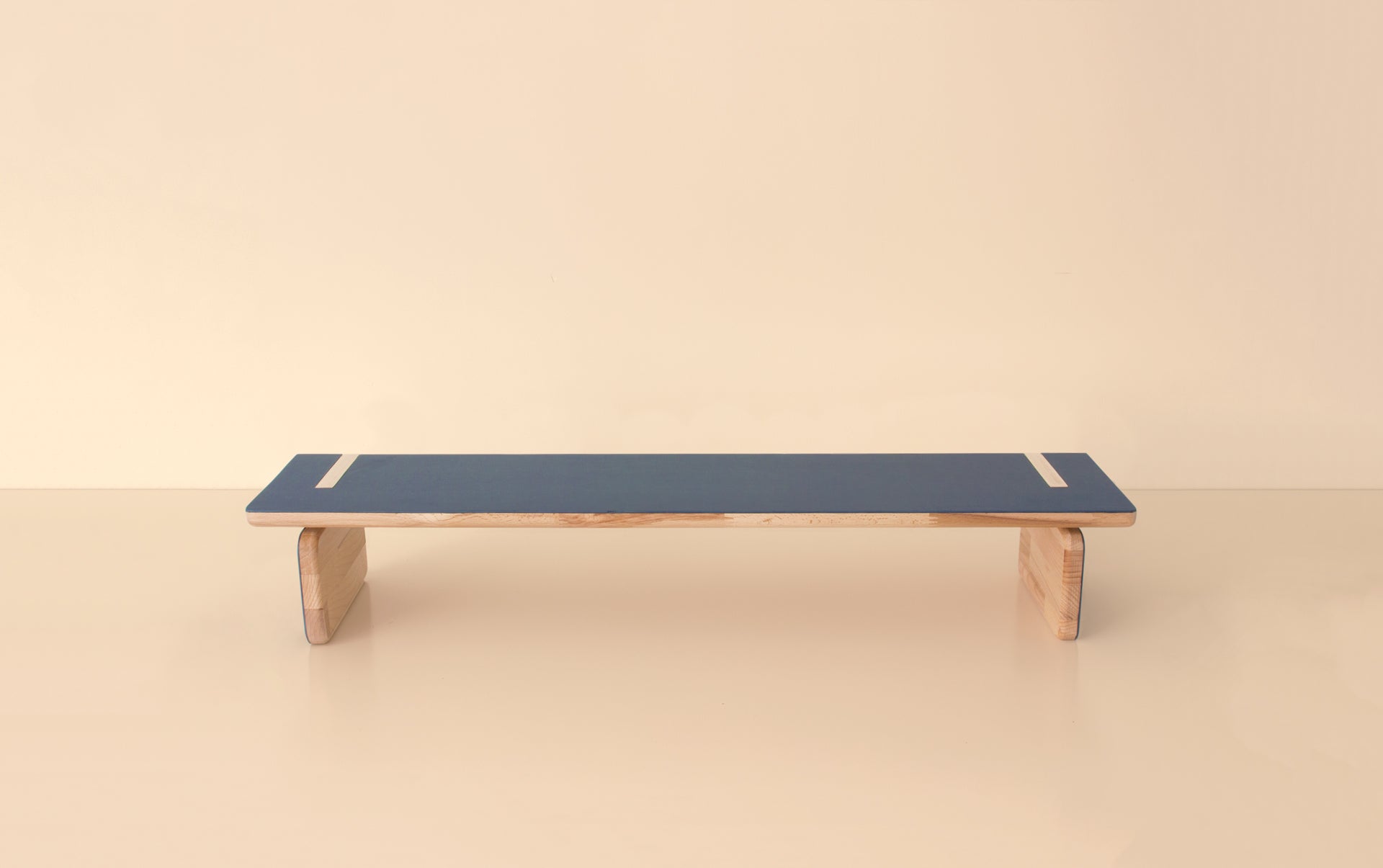 Front view of elegant natural wood bench with blue top and sturdy curved wooden legs