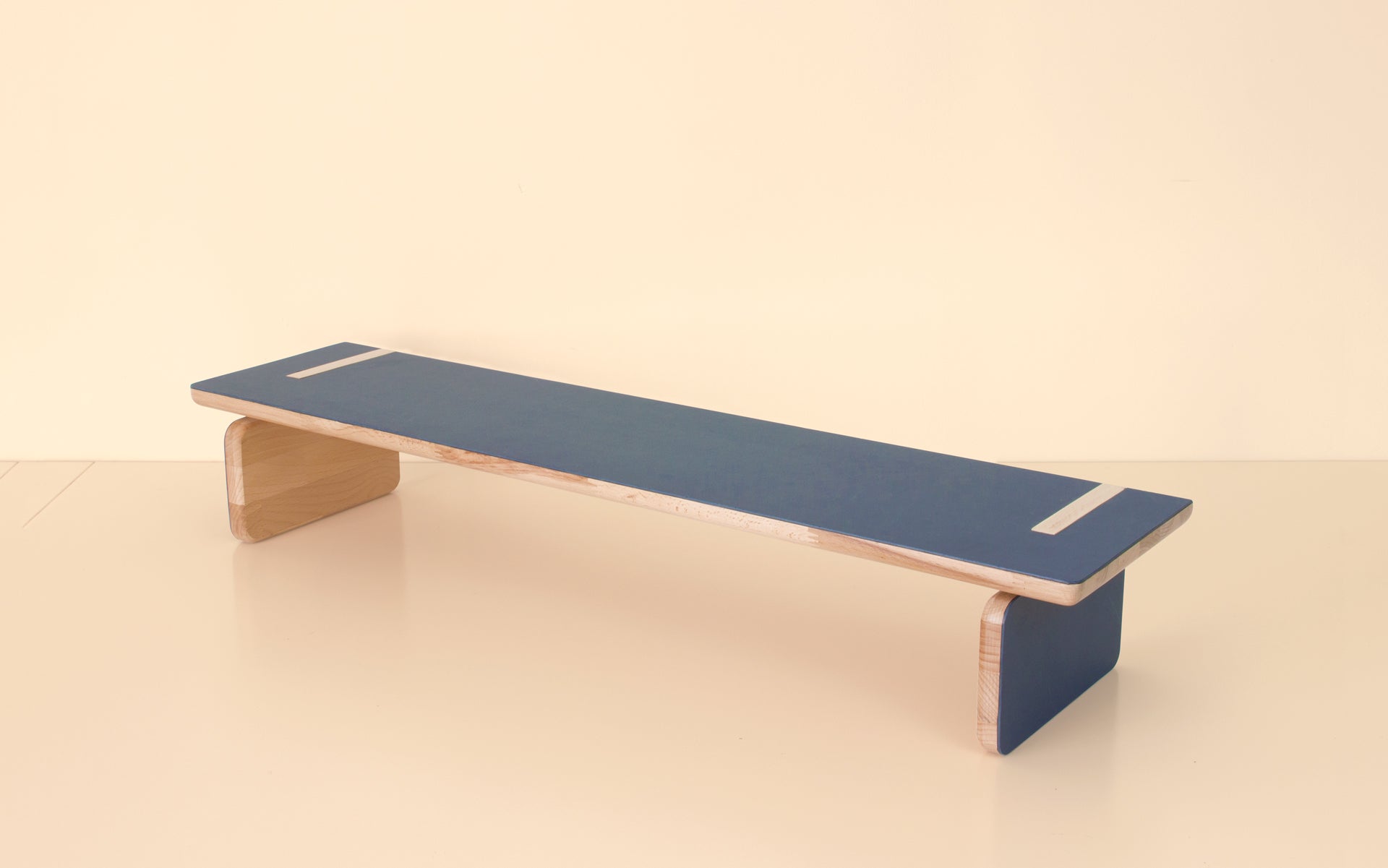 Perspective view showcasing the sleek design and craftsmanship of the blue and natural wood bench