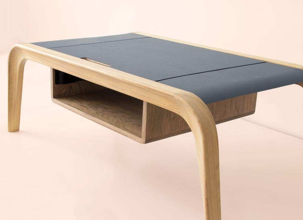 Close-up of extendable dark tabletop section on natural oak coffee table