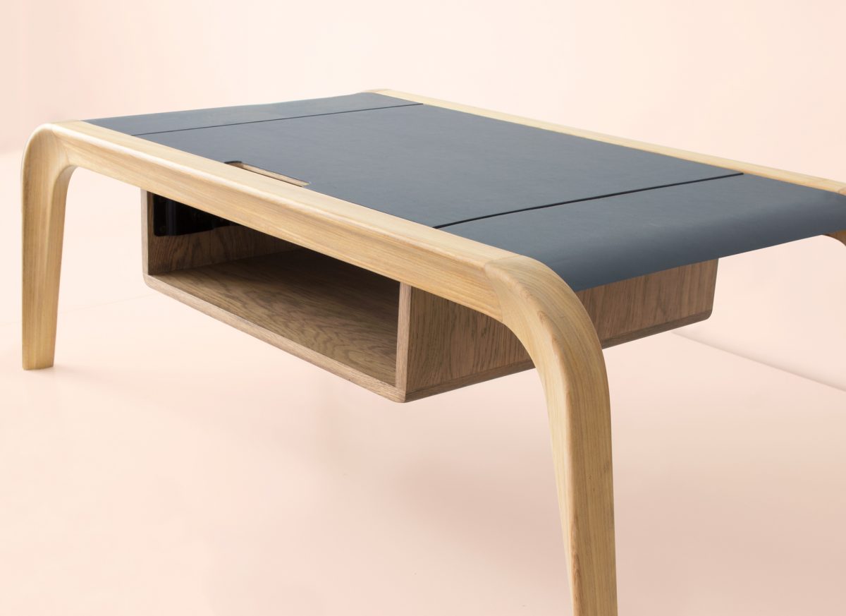 Close-up of extendable dark tabletop section on natural oak coffee table